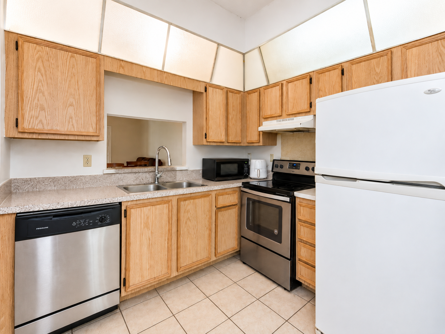The same kitchen with clear counters, bright and ready for the listing